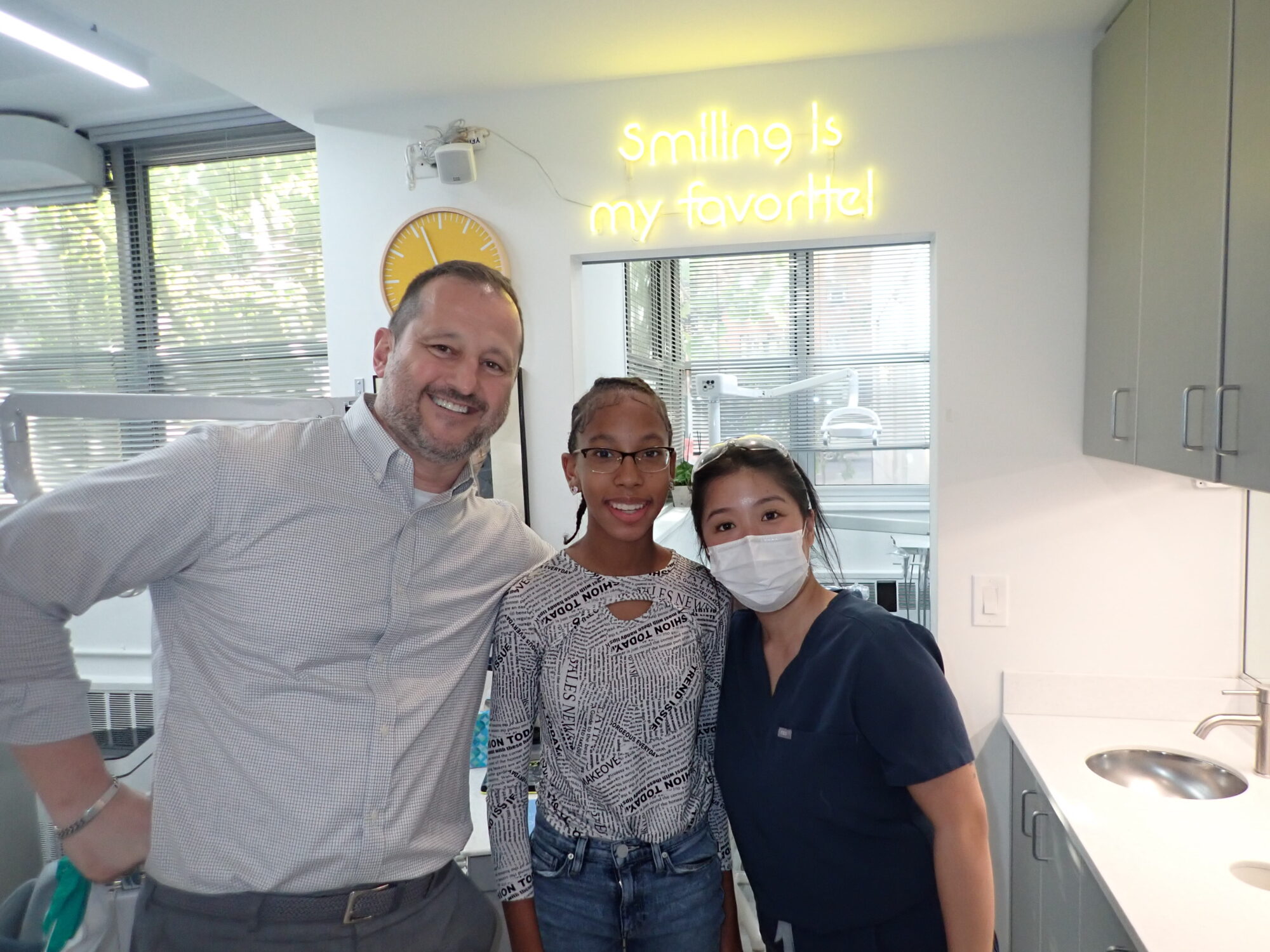 Invisalign Manhattan Clear Aligner Treatment Patient smiling during Invisalign treatment in Manhattan using clear aligners