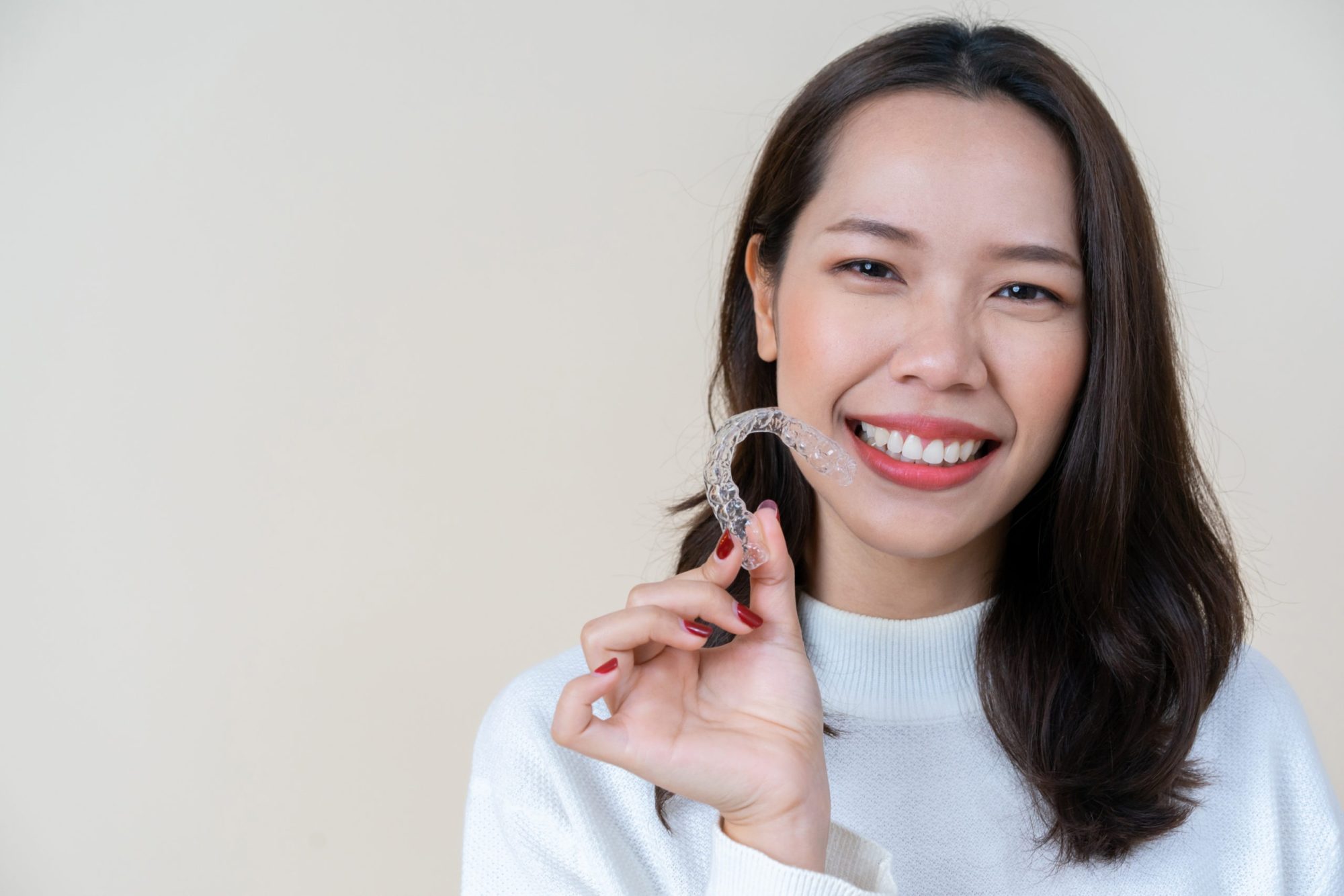 Clear Aligners Consultation with a Manhattan Orthodontist Manhattan orthodontist helping a patient with clear aligners as a discreet alternative to braces