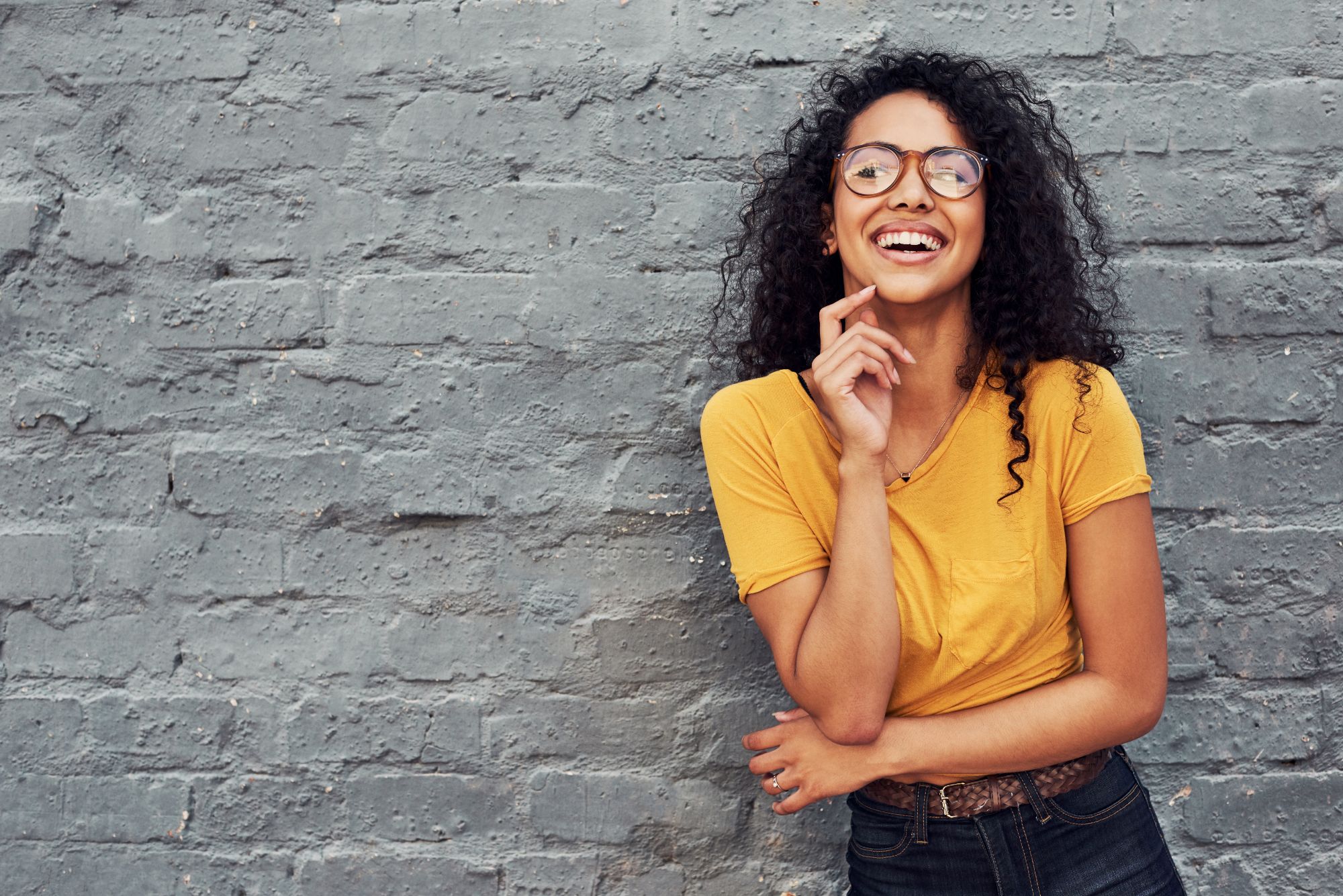 Invisalign Manhattan – Patient Smiling with Clear Aligners Smiling patient wearing Invisalign clear aligners at an orthodontic office in Manhattan