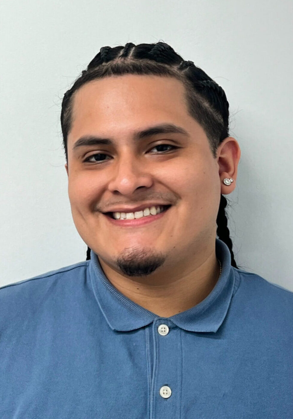 Joseph, Manhattan Orthodontics Patient Treatment Coordinator, smiling portrait.